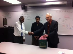 Stewart Rosenberg and Leonille and Zato Kadambaya shake hands over africaphilanthropies inc and bio-investigations ltd partnering